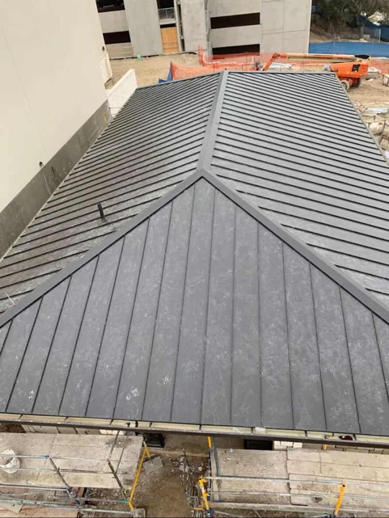 Commercial metal roof construction with crane equipment in Windsor